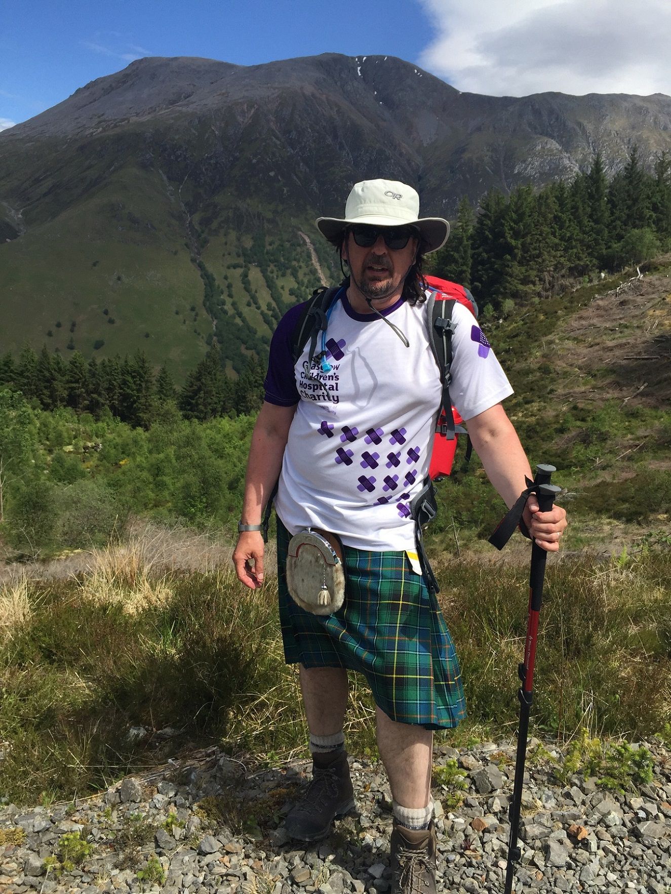 michael in kilt standing on mountain resize
