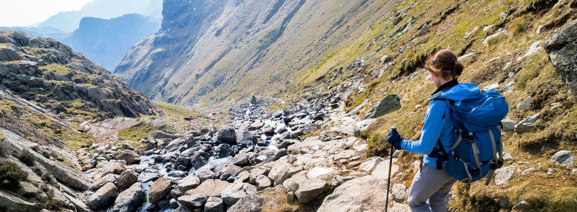 Trekking with poles over rocks in the Lake District