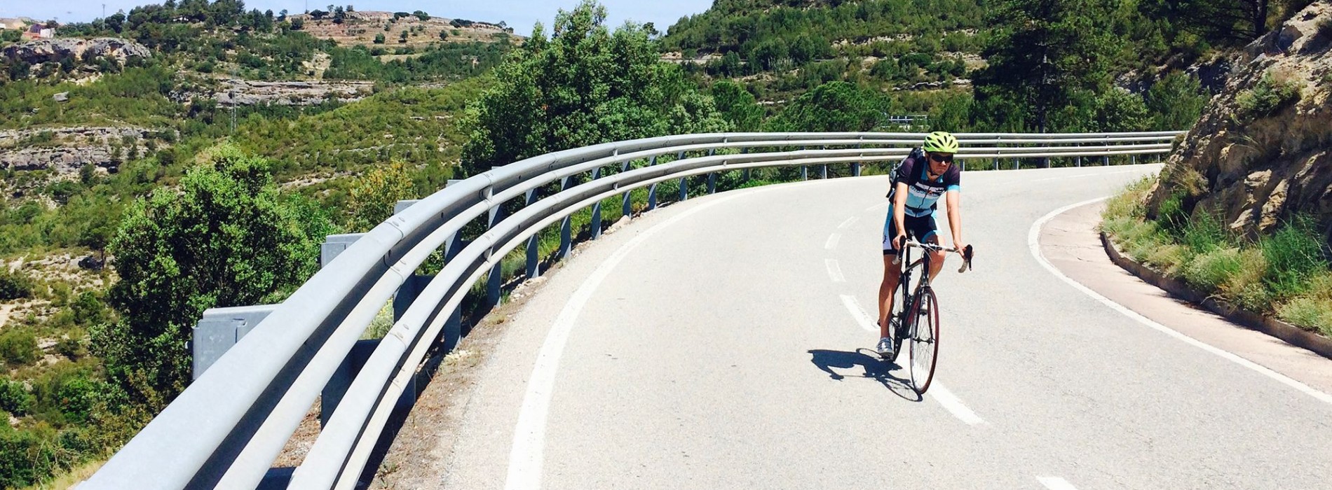 Cyclists_on_bend_in_road_Carcassonne_to_Barcelona_cycle.jpg