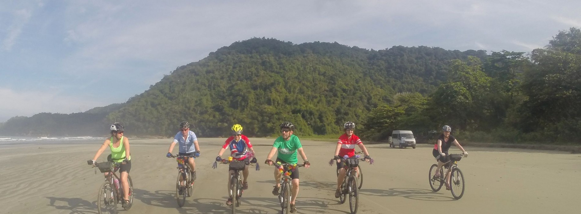 Cyclist_crossing_beach_Brazil.jpg